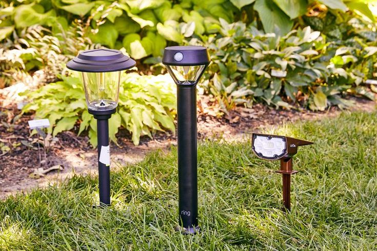 "Energy-efficient outdoor solar lights illuminating a modern garden pathway at night. Stylish solar-powered fixtures designed for sustainable outdoor lighting solutions."